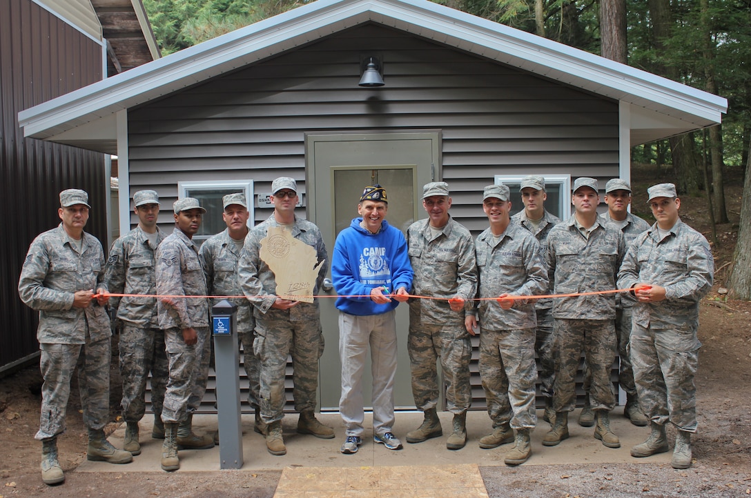 Airmen with the Civil Engineer Squadron, 128th Air Refueling Wing, Wisconsin Air National Guard, pose with Kevin Moshea, the director of Camp American Legion, at a ribbon-cutting ceremony for the new fish-cleaning station Sept. 24, 2016. The Airmen assisted in building the station Sept. 17-25, 2016 in Lake Tomahawk, Wis.  (U.S. Air Force photo by Senior Master Sgt. Kyle Fugar/Released)