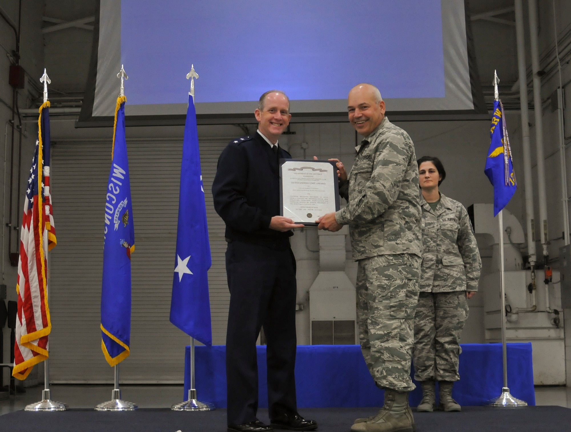 Major General Donald P. Dunbar (left), Adjutant General of the Wisconsin National Guard, presents the Air Force Outstanding Unit Award to Col. Daniel Yenchesky, commander of the 128th Air Refueling Wing, in a formal ceremony Oct. 2, 2016 at General Mitchell Airfield, Milwaukee. This award marks the seventh time the 128 ARW has received the AFOUA in recognition of distinguished meritorious service from Oct. 1, 2014 through Sept. 30, 2015. (Air National Guard photo by Senior Airman Morgan R. Lipinski, 128 ARW Public Affairs/Released) 