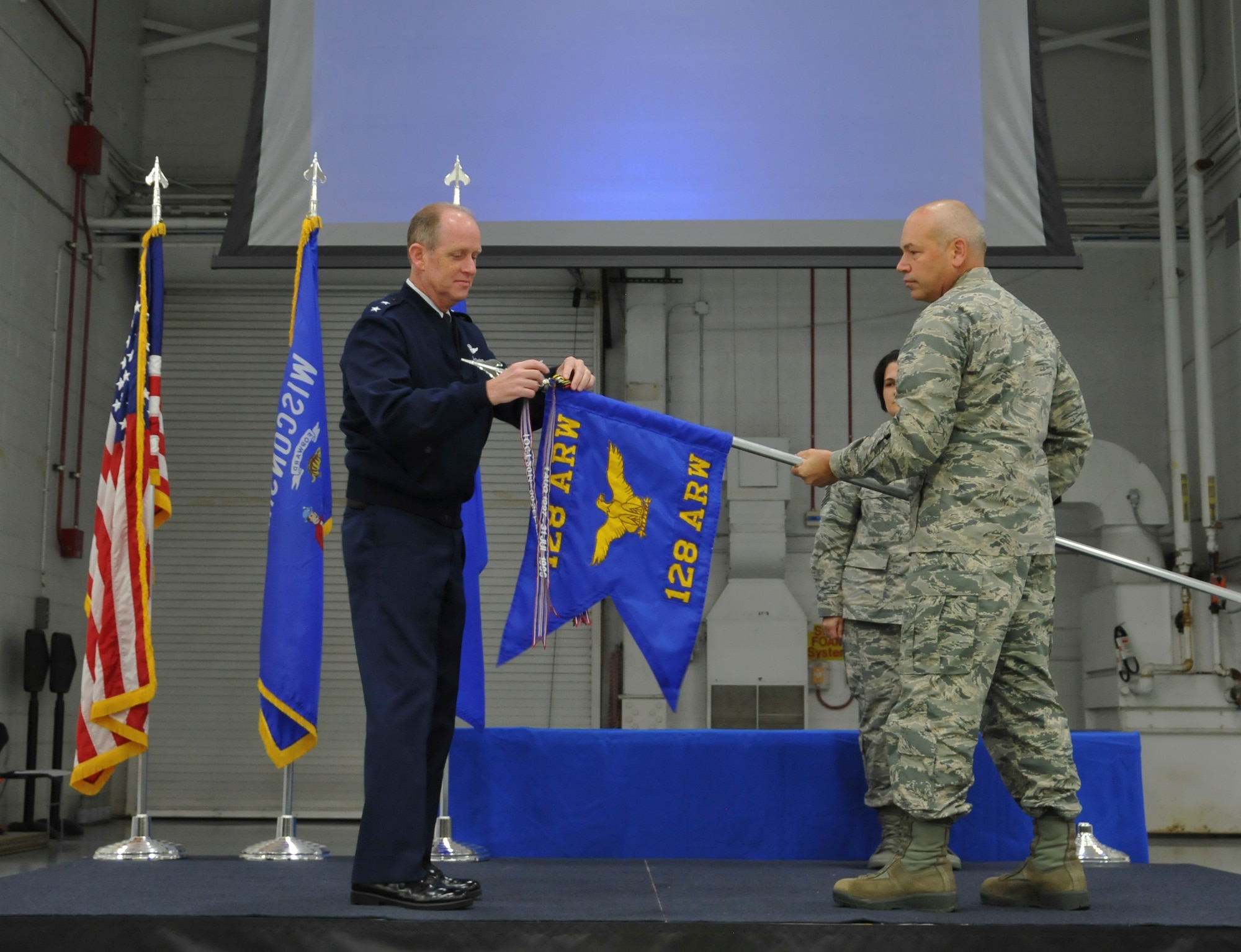 Major General Donald P. Dunbar, Adjutant General of the Wisconsin National Guard, presents the Air Force Outstanding Unit Award to Col. Daniel Yenchesky, commander of the 128th Air Refueling Wing in a formal ceremony Oct. 2, 2016 at General Mitchell Airfield, Milwaukee. This award marks the seventh time the 128 ARW has received the AFOUA and covers the period of Oct. 1, 2014 through Sept. 30, 2015. (Air National Guard photo by Senior Airman Morgan R. Lipinski, 128 ARW Public Affairs/Released) 