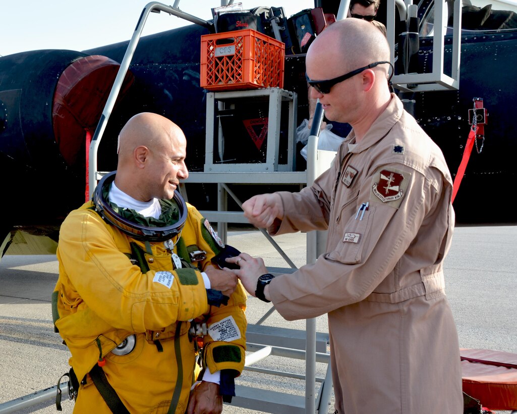 Lt. Col. Ralph, 99th Expeditionary Reconnaissance Squadron U2 pilot, receives a new patch from Lt. Col. William, 99th ERS commander. The patch commemorates a career milestone for Ralph, who had just achieved 2,000 flying hours in the U2. (U.S. Air Force photo by Staff Sgt. Samantha Mathison)