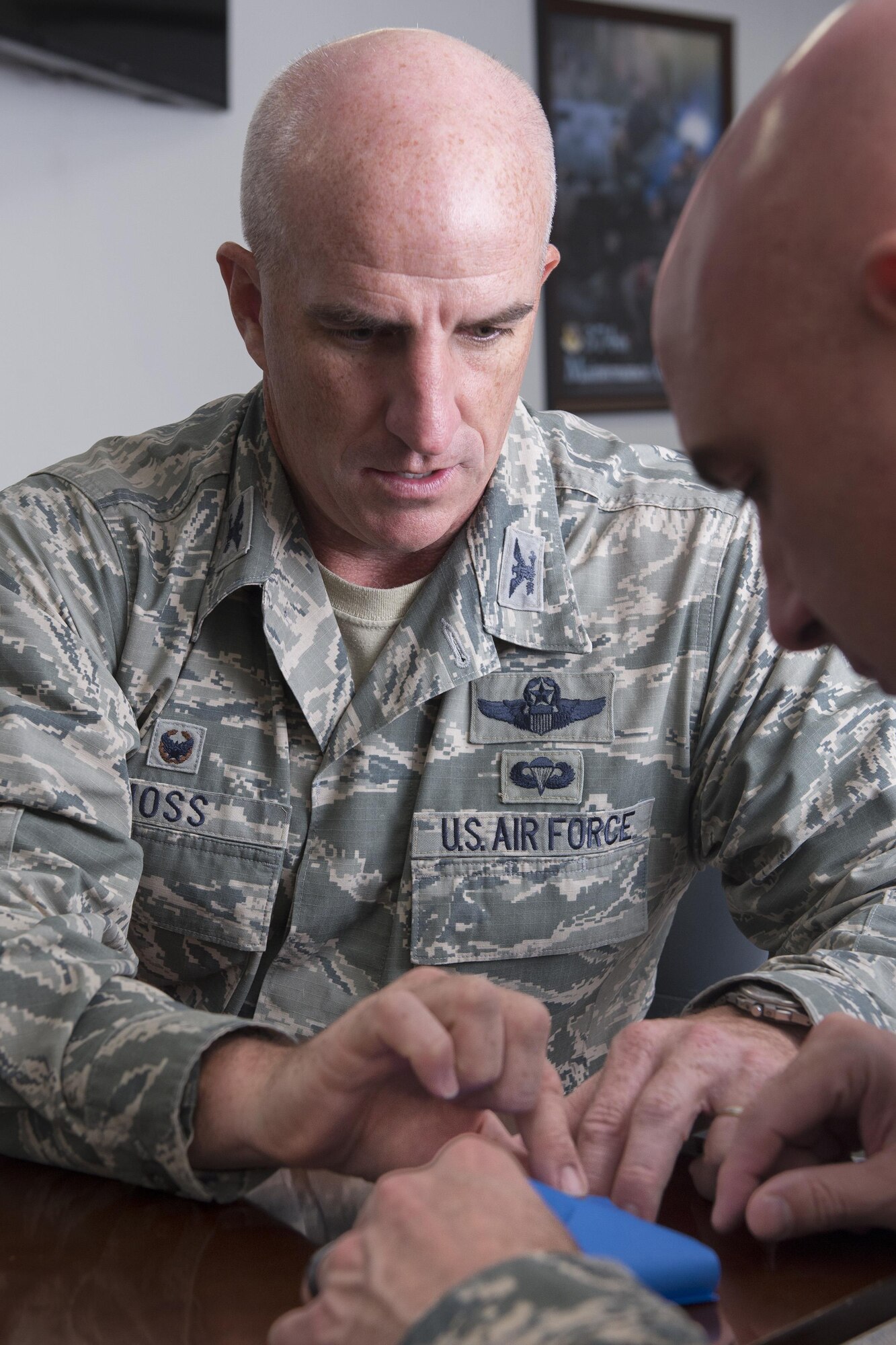 Col. Kenneth Moss, left, 374th Airlift Wing commander, folds an origami crane with Chief Master Sgt. Christopher Yevchak, 374 AW command chief, during the 2016 CFC-O kickoff at Yokota Air Base, Japan, Oct. 3, 2016. Yokota’s CFC-O representatives plan to collect 1,000 origami cranes to grant a symbolic wish. (U.S. Air Force photo by Yasuo Osakabe/Released) 