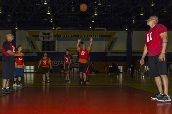 Athletes play basketball during the Special Olympics Nippon Hiroshima at Marine Corps Air Station Iwakuni, Japan, Oct. 2, 2016. Activities held at the Special Olympics included basketball, futsal, tennis, bowling and a duathlon. This program provides year-round training for upcoming competitions in a variety of Olympic-style sports, and it is catered to children and adults with mental and learning disabilities. (U.S. Marine Corps photo by Lance Cpl. Aaron Henson)