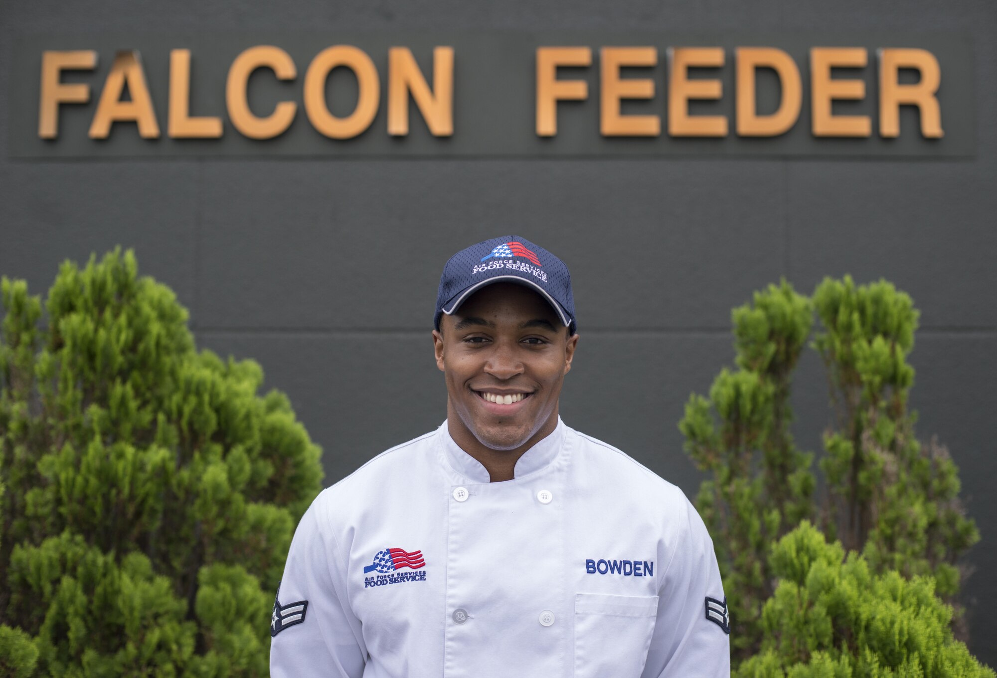 U.S. Air Force Airman 1st Class Zach Bowden, the falcon feeder shift leader with the 35th Force Support Squadron, poses in front of the falcon feeder at Misawa Air Base, Japan, Sept. 29, 2016. Bowden currently works at the falcon feeder located on the flight line, but will shortly be moving to the Potter Fitness Center. Bowden said he loves working in FSS becuase it allows him to meet people and provide them with a good meal when they need it the most. (U.S. Air Force photo by Senior Airman Brittany A. Chase)