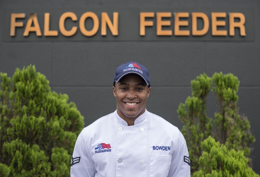 U.S. Air Force Airman 1st Class Zach Bowden, the falcon feeder shift leader with the 35th Force Support Squadron, poses in front of the falcon feeder at Misawa Air Base, Japan, Sept. 29, 2016. Bowden currently works at the falcon feeder located on the flight line, but will shortly be moving to the Potter Fitness Center. Bowden said he loves working in FSS becuase it allows him to meet people and provide them with a good meal when they need it the most. (U.S. Air Force photo by Senior Airman Brittany A. Chase)