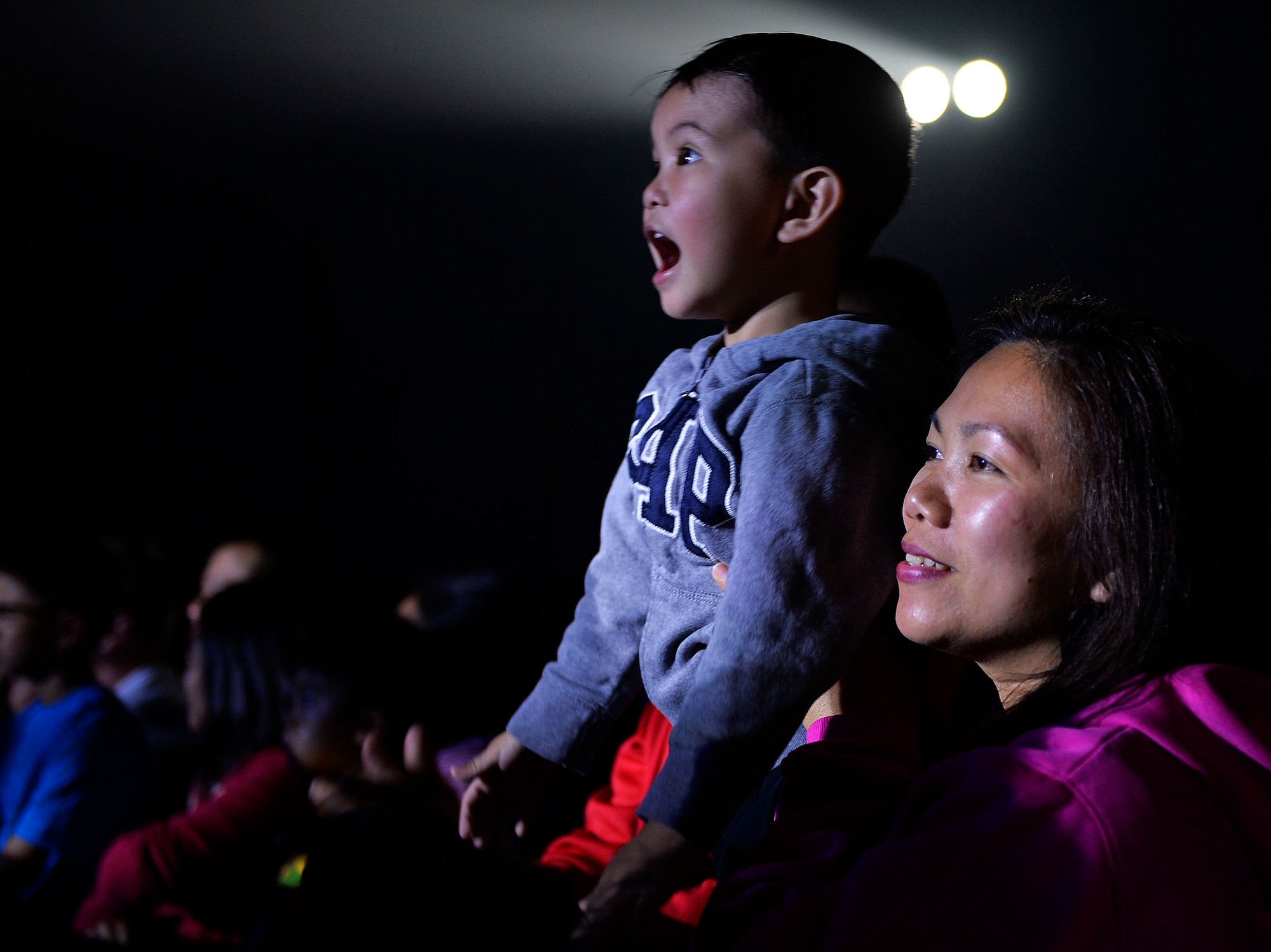 U.S. Department of Defense I.D. cardholders and their families watch a free magic show performed by Rob Lake at Ramstein Air Base, Germany, Sept. 28, 2016. Lake and his team conduct tours with Armed Forces Entertainment as a show of appreciation for U.S. Military members serving overseas. (U.S. Air Force photo/ Airman 1st Class Joshua Magbanua)