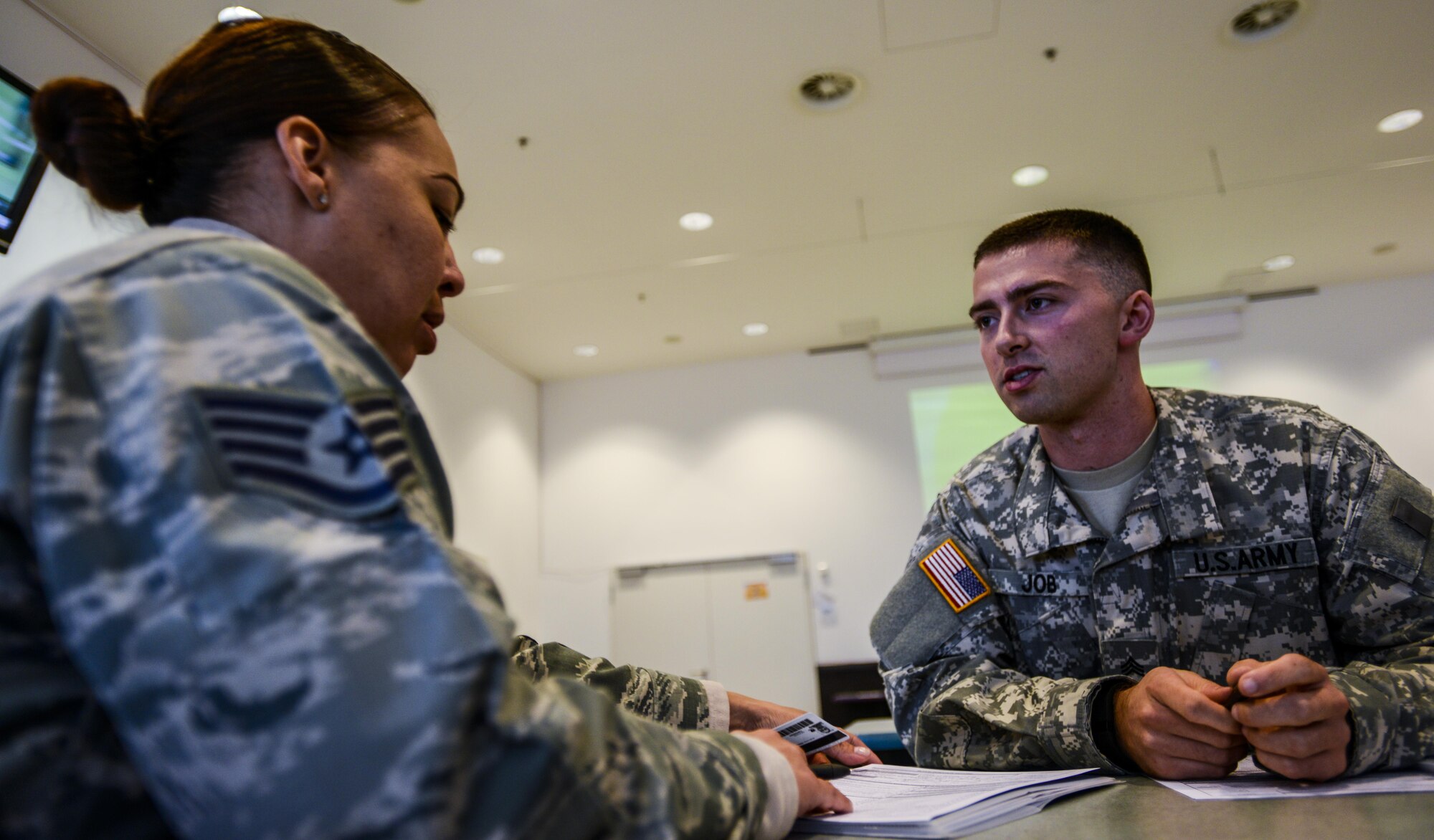 U.S. Army Sgt. Adam Job, C Company, Landstuhl Regional Medical Center medical laboratory technician, conducts a pre-screen examination of U.S. Air Force Staff Sgt. Deeanne Rosario, a Reservist air transportation journeyman with the 73rd Aerial Port Squadron, Fort Worth, Texas, during a blood drive at the Kaiserslautern Military Community Center, Sept. 20, 2016. The pre-screen examination identifies situations and circumstances that would disqualify a person from donating blood. (U.S. Air Force photo by Staff Sgt. Timothy Moore)