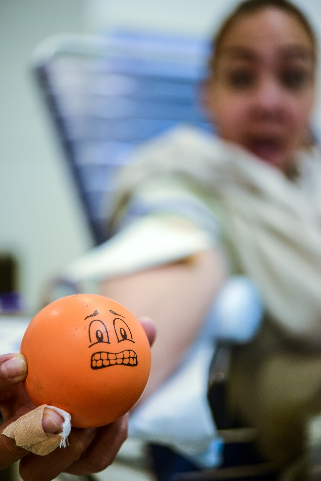 U.S. Air Force Staff Sgt. Deeanne Rosario, a Reservist air transportation journeyman with the 73rd Aerial Port Squadron, Fort Worth, Texas, holds a stress ball as she is prepares to donate blood during an Armed Services Blood Program-Europe blood drive at the Kaiserslautern Military Community Center, Sept. 20, 2016. The ASBP collected blood to be used by U.S. service members and their families. The majority of the blood collected is sent to deployed locations. (U.S. Air Force photo by Staff Sgt. Timothy Moore)