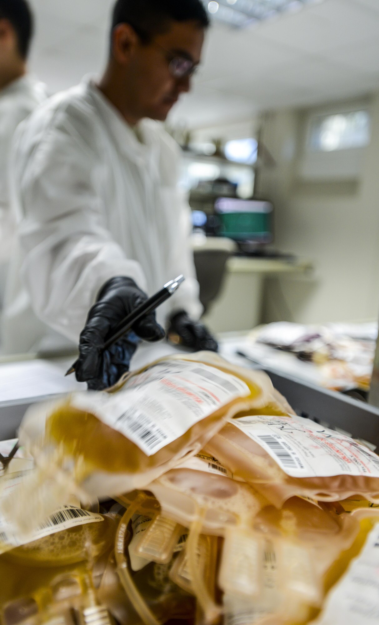 U.S. Army Sgt. Victor Castillo, C Company, Landstuhl Regional Medical Center medical laboratory technician, places a bag of plasma into a container at LRMC, Sept. 22, 2016. After being separated from each other, both the plasma and blood are weighed to get the actual amount collected. While the separated blood is used for transfusions, the plasma is used if a person is having trouble clotting and stopping blood loss. (U.S. Air Force photo by Staff Sgt. Timothy Moore)