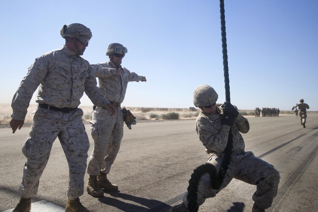 Marine Corps Staff Sgt. Mitchell T. Antonaccio, left, and Capt. Timothy J. Reynolds supervise during a fast-rope exercise at Auxiliary Airfield 2 in Yuma, Ariz., Sept. 30, 2016. Antonaccio is assigned to the 3rd Marine Division's 2nd Battalion, 3rd Marine Regiment. Reynolds is assigned to the regiment's 1st Battalion. Marine Corps photo by Cpl. Aaron James Vinculado