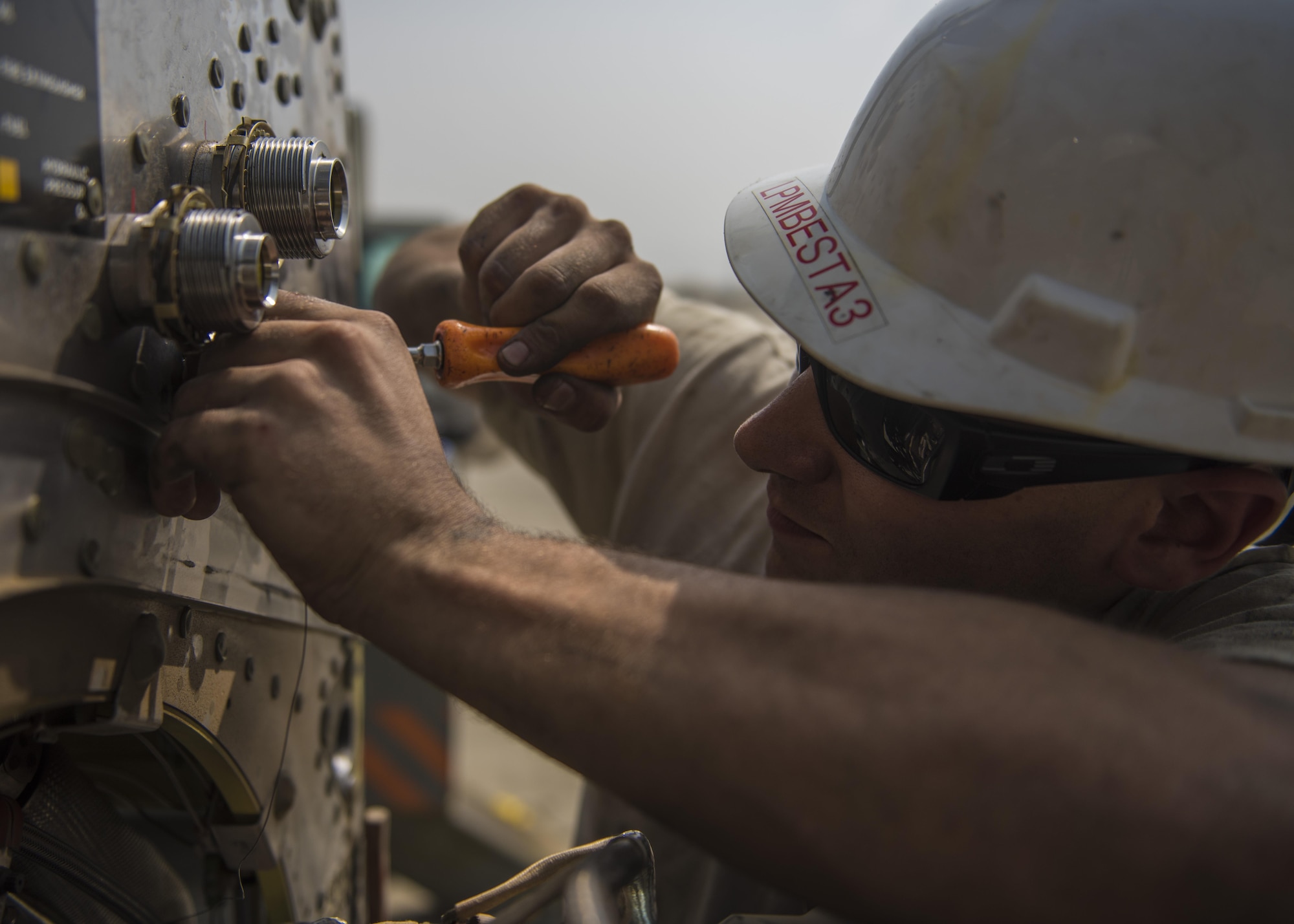 Senior Airman Thomas Budd, 455th Expeditionary Aircraft Maintenance Squadron electrician, safety wires a fire loop on a C-130J Super Hercules, Oct. 01, 2016. The fire overheat protection system lets the aircraft crew know if the engine is at risk to catch fire. If the protective system catches fire, the crew can shut off all liquids flowing towards the engine to prevent an engine fire or explosion. (U.S. Air Force photo by Senior Airman Justyn M. Freeman)