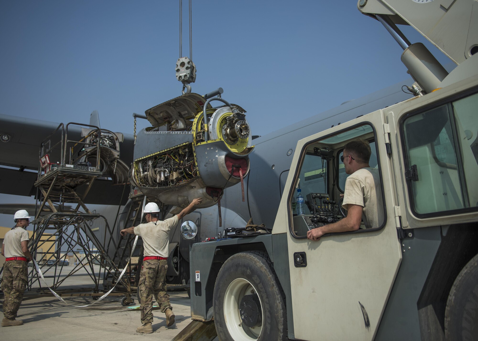 Airmen from the 455th Expeditionary Aircraft Maintenance Squadron, install a new engine on a C-130J Super Hercules, Oct. 01, 2016, Bagram Airfield, Afghanistan. Members of the 455th EAMXS replaced the old engine due to malfunction. (U.S. Air Force photo by Senior Airman Justyn M. Freeman)
