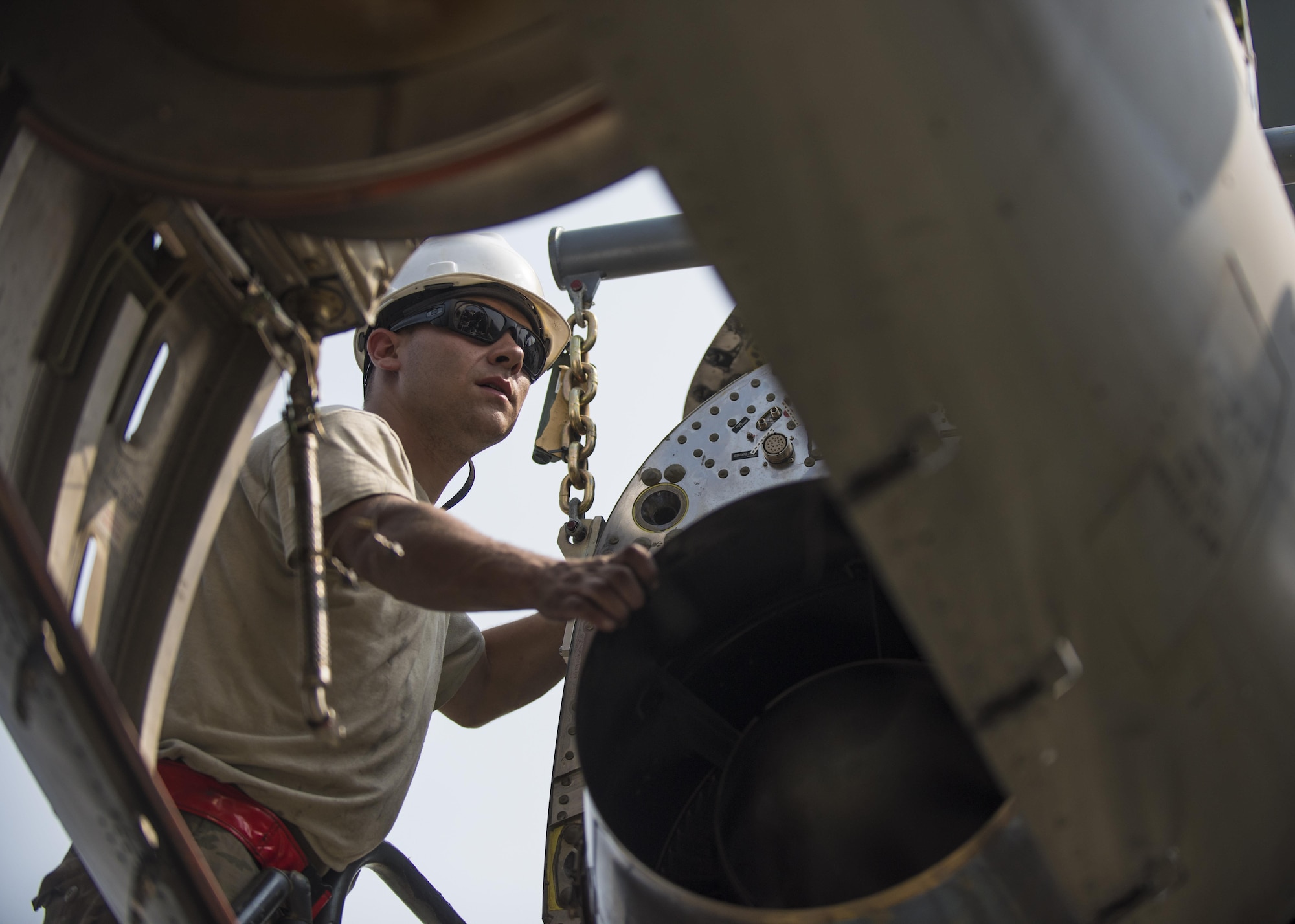 Senior Airman Thomas Budd, 455th Expeditionary Aircraft Maintenance Squadron electrician, guides a new C-130J Super Hercules engine into place, Bagram Aifield, Afghanistan, Oct. 01, 2016. Members of the 455th EAMXS replaced the old engine due to malfunction. (U.S. Air Force photo by Senior Airman Justyn M. Freeman)