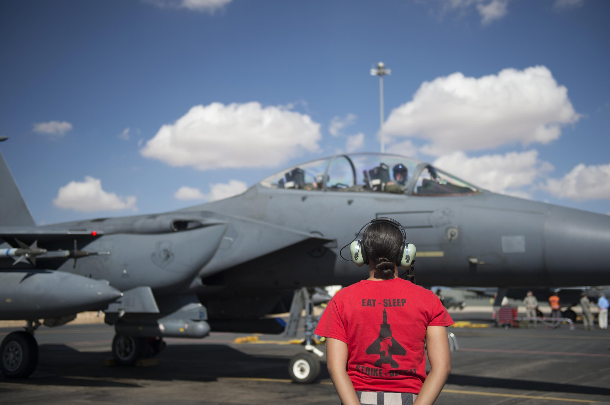 U.S. Air Force Airman 1st Class Alexis Rodriguez, 48th Air Craft Maintenance Squadron aircraft armament system technician, stands by to marshal out an F-15E Strike Eagle before a sortie in support of Tactical Leadership Programme 16-3 at Los Llanos Air Base, Spain Sept. 30. Throughout its 39-year history, TLP has become the focal point for NATO’s Allied Air Forces tactical training, developing the knowledge and leadership skills necessary to face today's tactical challenges in the air. (U.S. Air Force photo/ Staff Sgt. Emerson Nuñez)