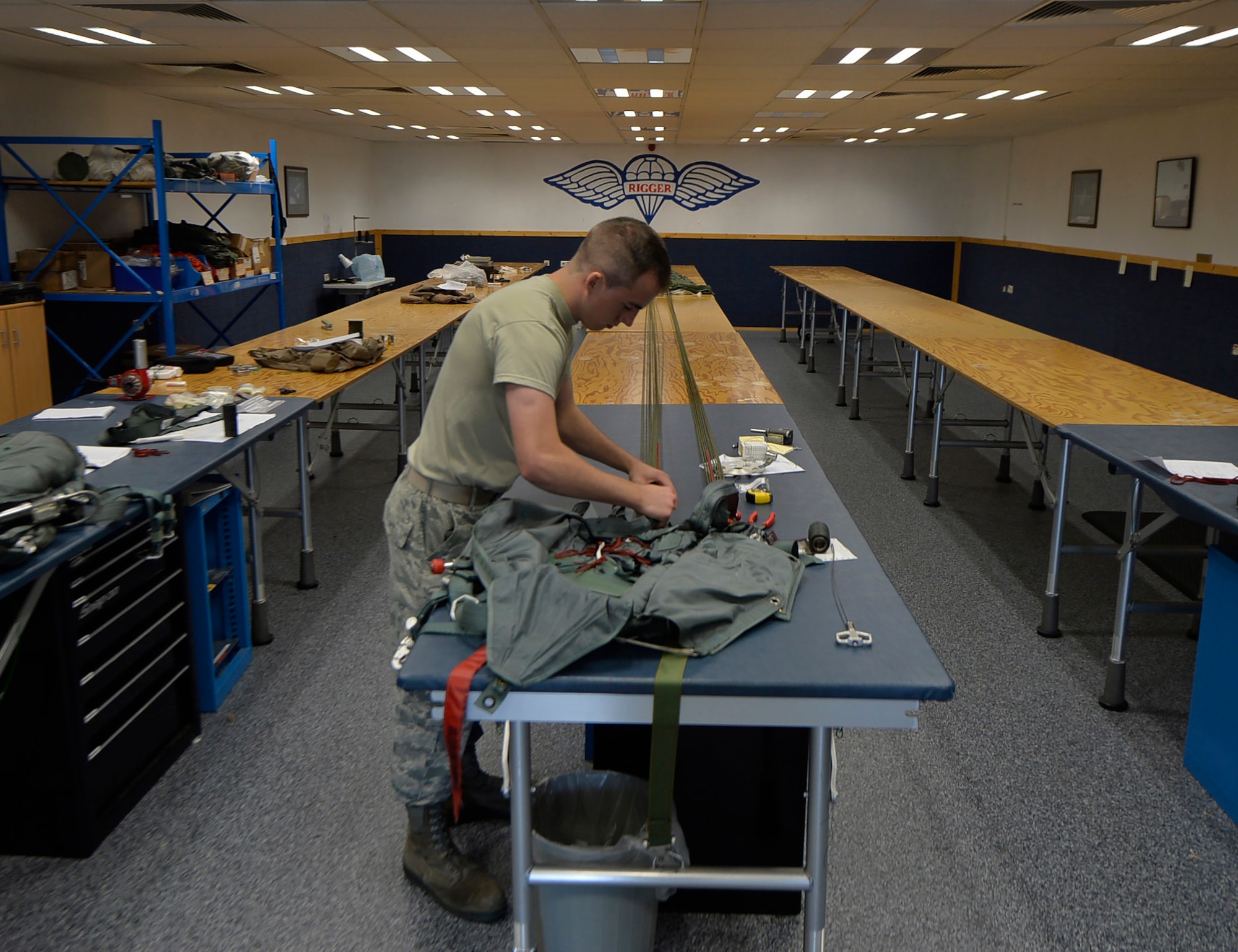 Airman 1st Class Caleb Witham, 86th Operations Support Squadron aircrew flight equipment apprentice, repacks a BA-22 parachute, July 25, 2016 at Ramstein Air Base, Germany. The AFE flight rotates Airmen in support of the 76th Airlift Squadron and the 37th AS mission. (U.S. Air Force photo/Senior Airman Nesha Humes)