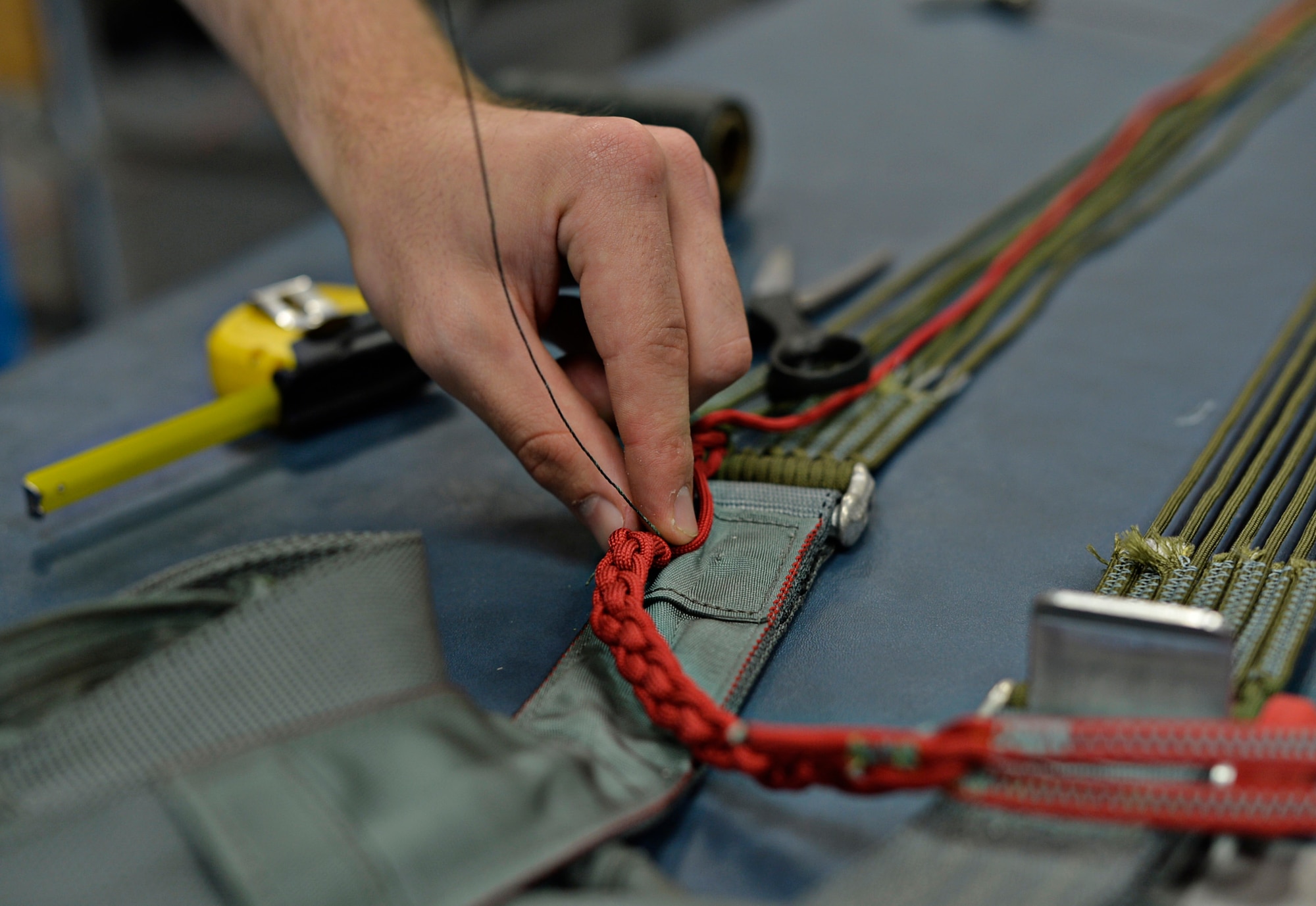 Airman 1st Class Caleb Witham, 86th Operations Support Squadron aircrew flight equipment apprentice, tacks a four-line Jenson on a BA-22 parachute for annual inspections, July 25, 2016 at Ramstein Air Base, Germany. Attention to detail is key for AFE Airmen; they repair, test and inspect all flight equipment and must ensure it is fully operational for aircrew in everyday and emergency situations. (U.S. Air Force photo/Senior Airman Nesha Humes)