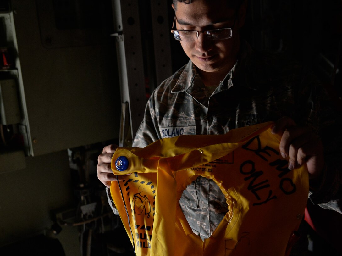 Senior Airman Gregory Solano, 86th Operations Support Squadron aircrew flight equipment journeyman, inspects a life vest onboard a C-130J Super Hercules, Sept. 20, 2016 at Ramstein Air Base, Germany.  AFE Airmen perform mission termination inspections on aircraft daily with more thorough inspections for tears every 30 days. (U.S. Air Force photo/Senior Airman Nesha Humes)