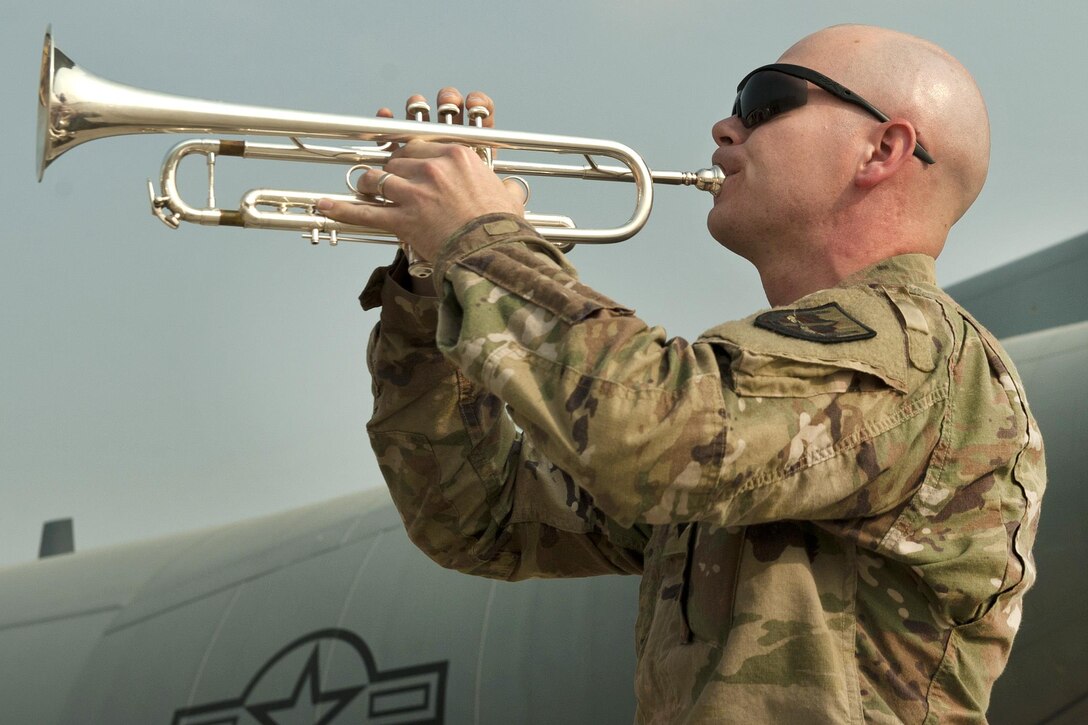 A soldier plays taps during the TORQE 62 remembrance ceremony at Bagram Airfield, Afghanistan, Oct. 2, 2016. The soldier is a musician assigned to the U.S. Forces Afghanistan Band. Air Force photo by Capt. Korey Fratini