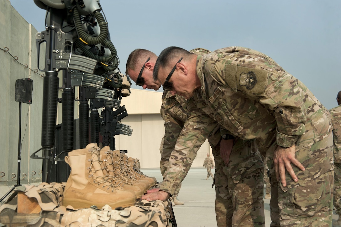 Air Force Brig. General James Sears, left, commander, 455th Air Expeditionary Wing, and Air Force Chief Master Sgt. Peter Speen, command chief, 455th Air Expeditionary Wing pause to honor six fallen airmen during the TORQE 62 remembrance ceremony at Bagram Airfield, Afghanistan, Oct. 2, 2016. Air Force photo by Capt. Korey Fratini