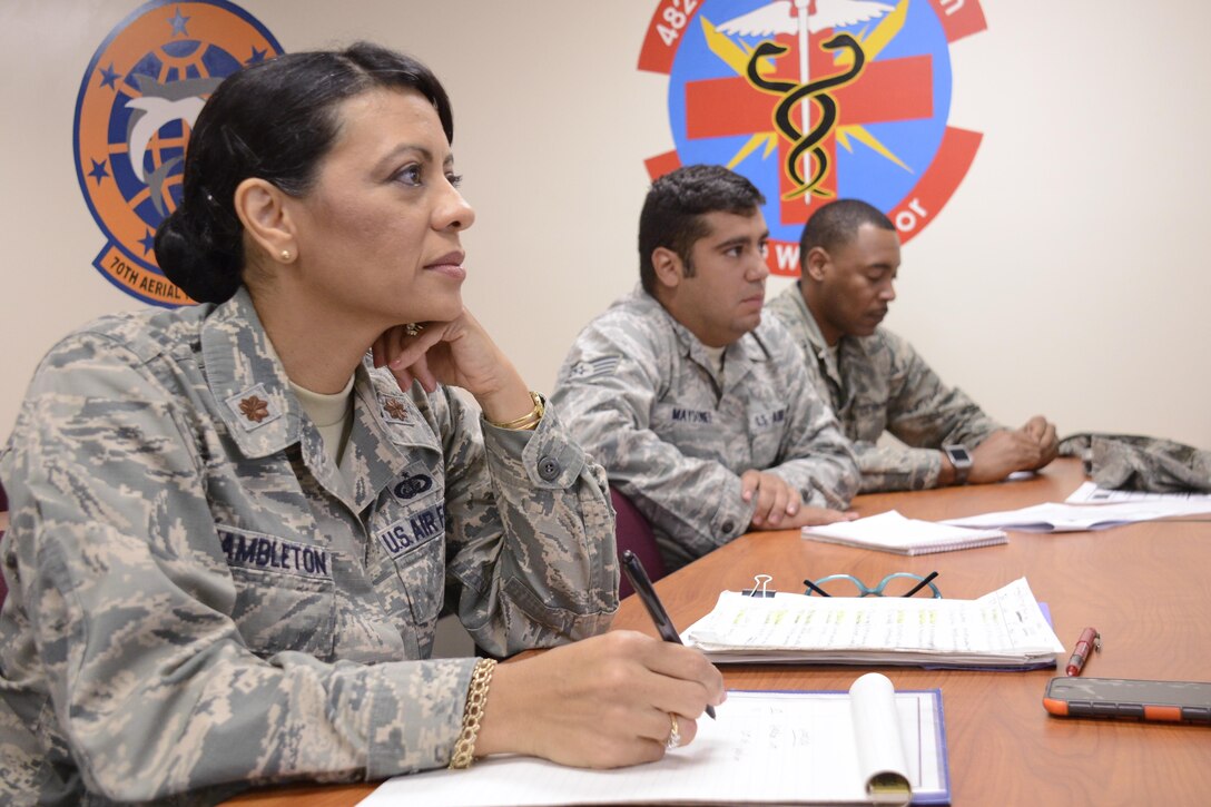 Maj. Roxy Hambleton, the 482nd Force Support Squadron officer in charge of military personnel,  takes notes while listening to a person practicing a speech at one of her public speaking workshops at Homestead Air Reserve Base, Florida. (U.S. Air Force photo/Senior Airman Frank Casciotta)