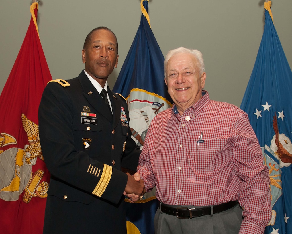 DLA Troop Support Commander Army Brig. Gen. Charles Hamilton, left, presents Stephen DiLizio, business process analyst, with a Vietnam War veteran pin to honor his service during the war at a Quarterly Awards ceremony Sept. 28.