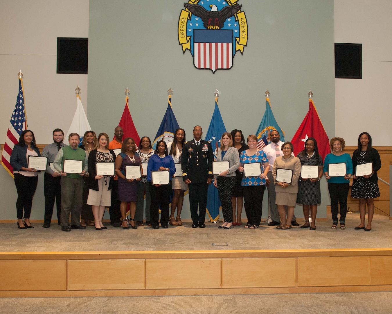 DLA Troop Support Commander Army Brig. Gen. Charles Hamilton, center, presents employees who volunteered to tutor local students with certificates of appreciation during a Quarterly Awards ceremony Sept. 28. Project Government and Industry Volunteers for Education participants tutored third grade students at Benjamin Franklin Elementary school bi-weekly during the 2015-2016 school year.