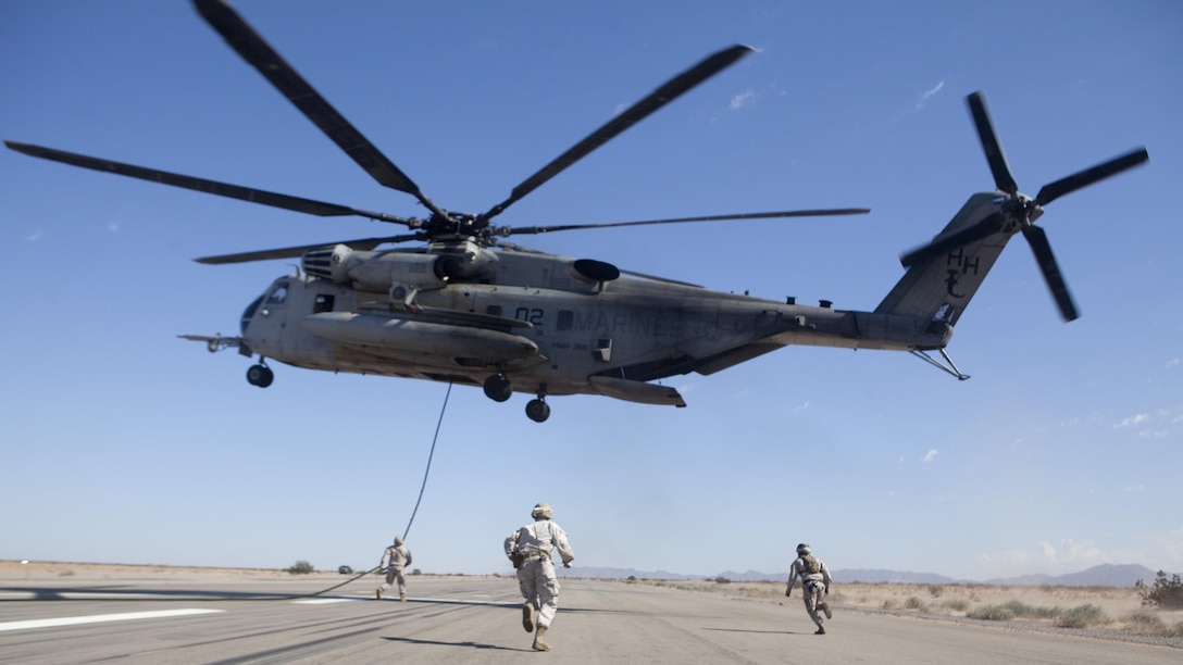 U.S. Marines with Fox Company, 2nd Battalion, 3rd Marine Regiment, 3rd Marine Division prepare to fast rope out of a CH-53E Super Stallion at Auxiliary Airfield 2, Yuma, Ariz., Sept. 30, 2016. The exercise was part of Weapons and Tactics Instructor course 1-17, a seven week training event hosted by Marine Aviation Weapons and Tactics Squadron One cadre. MAWTS-1 provides standardized advanced tactical training and certification of unit instructor qualifications to support Marine Aviation Training and Readiness and assists in developing and employing aviation weapons and tactics.