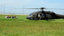 A team of volunteers act as adversaries exiting a UH-60 Blackhawk during training at Whiteman Air Force Base, Mo., Sept. 20, 2016. Their objective was to simulate an attempt to destroy Air Force resources on the flightline. (U.S. Air Force photo by Senior Airman Danielle Quilla) 