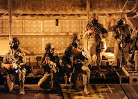 Members of the 509th Security Forces Squadron (SFS) prepare to sweep an area of a C-17 Globemaster III for hostile forces during training at Whiteman Air Force Base, Mo., Sept. 20, 2016. The training tested first and emergency responders in their ability to defeat a hostile force and identify hazards present. (U.S. Air Force photo by Senior Airman Danielle Quilla)