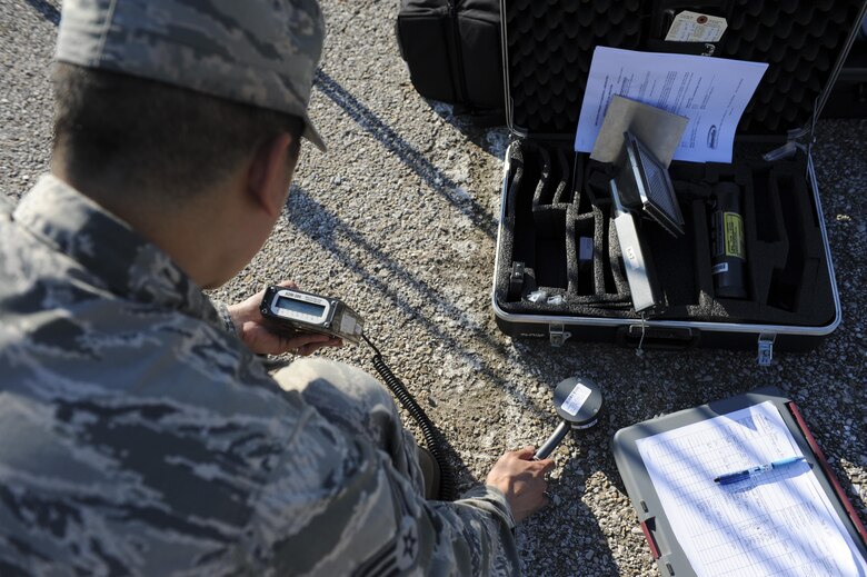 U.S. Air Force Senior Airman Emerson Malabuyoc, a bioenvironmental engineering technician with the 509th Medical Operation Squadron, simulates checking for beta radiation on the ground during training at Whiteman Air Force Base, Mo., Sept. 21, 2016. The training tested the emergency responders’ ability to handle a possible contamination incident. (U.S. Air Force photo by Senior Airman Danielle Quilla)