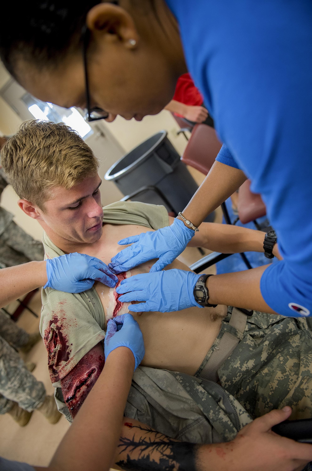 Members of the 96th Medical Group moulage team create simulated wounds on a 6th Ranger Training Battalion Soldier prior to a large-scale exercise Sept. 28 at Eglin Air Force Base, Fla.  The team made up cuts, breaks and lacerations for more than 12 Soldiers and civilians.  (U.S. Air Force photo/Samuel King Jr.)