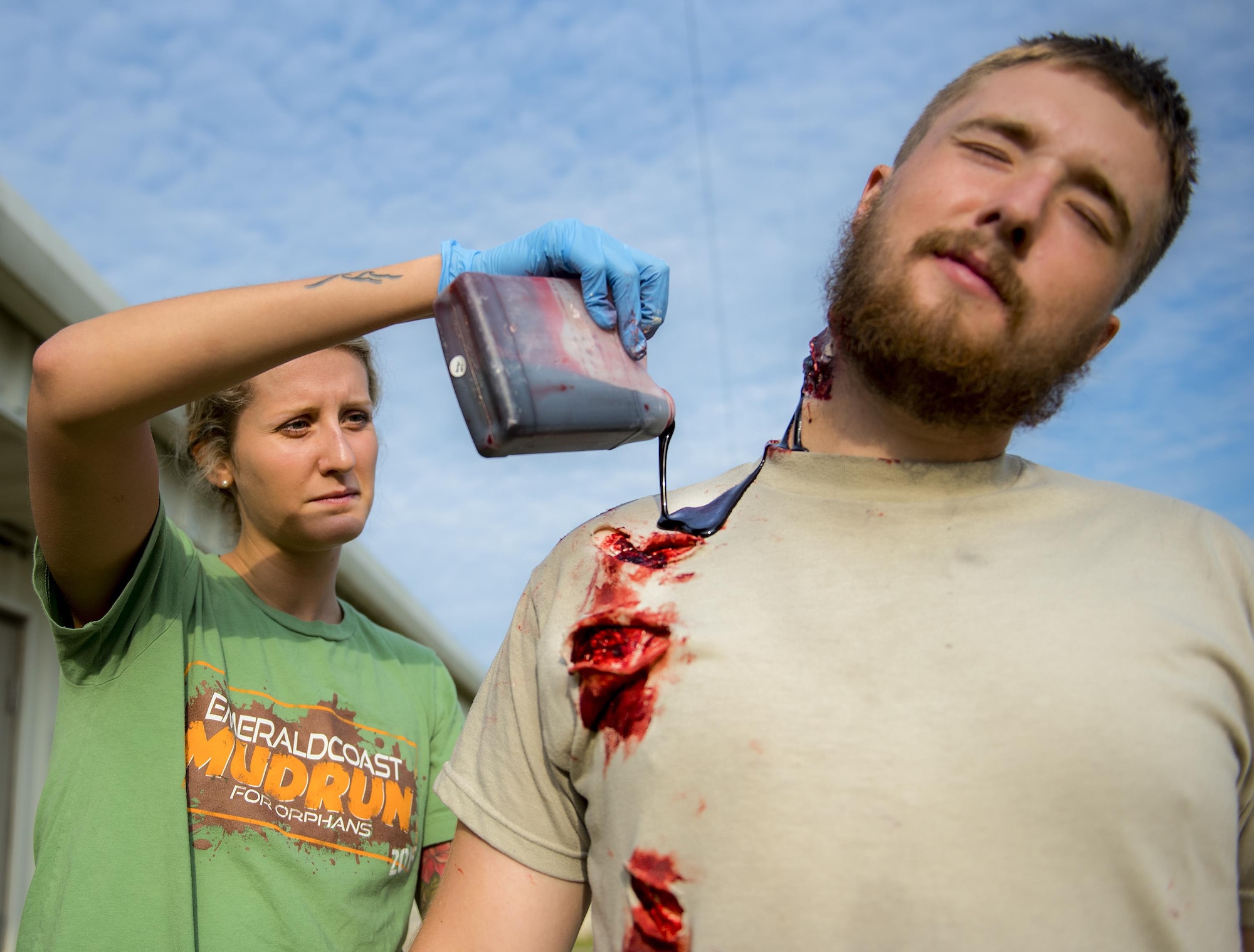 A member of the 96th Medical Group moulage team adds some blood to a simulated wound on a 6th Ranger Training Battalion Soldier prior to a large-scale exercise Sept. 28 at Eglin Air Force Base, Fla.  The team made up cuts, breaks and lacerations for more than 12 Soldiers and civilians.  (U.S. Air Force photo/Samuel King Jr.)