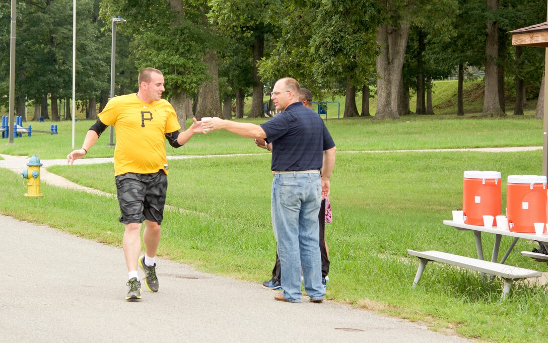 RICHMOND, Va. - Staff Sgt. Donald Albaugh, of the 7457th Medical Backfill Battalion, hydrates himself as he completes his first lap of the Suicide Prevention Awareness 5K Fun Run/Walk at the Defense Supply Center held here on Sep. 28, 2016. Albaugh was the first place winner overall with a run time of 25 minutes and 26 seconds. The 80th Training Command (TASS) held the event for all Department of Defense employees and their families. (Photo by Maj. Addie Randolph, 80th Training Command (TASS) Public Affairs)