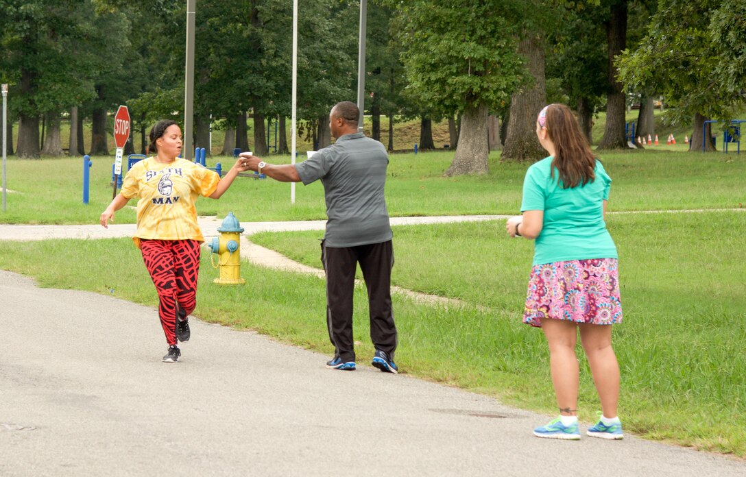 RICHMOND, Va. - 1st Lt. Kayla Duff, human resource manager for the 80th Training Command (TASS), grabs a sip of water as she completes her first lap of the Suicide Prevention Awareness 5K Fun Run/Walk at the Defense Supply Center held here on Sep. 28, 2016. The 80th TC held the event for all Department of Defense employees and their families. (Photo by Maj. Addie Randolph, 80th Training Command (TASS) Public Affairs)