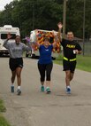 RICHMOND, Va. - (Left to right) Lt. Col. Julie Grant, human resources officer for the 80th Training Command (TASS), Mrs. Shelly Randall, and Maj. Thomas Randall, deputy staff judge advocate for the 80th TC, motivate each other as they race toward the finish line of the Suicide Prevention Awareness 5K Fun Run/Walk at the Defense Supply Center held here on Sep. 28, 2016. The 80th TC held the event for all Department of Defense employees and their families. (Photo by Maj. Addie Randolph, 80th Training Command (TASS) Public Affairs)