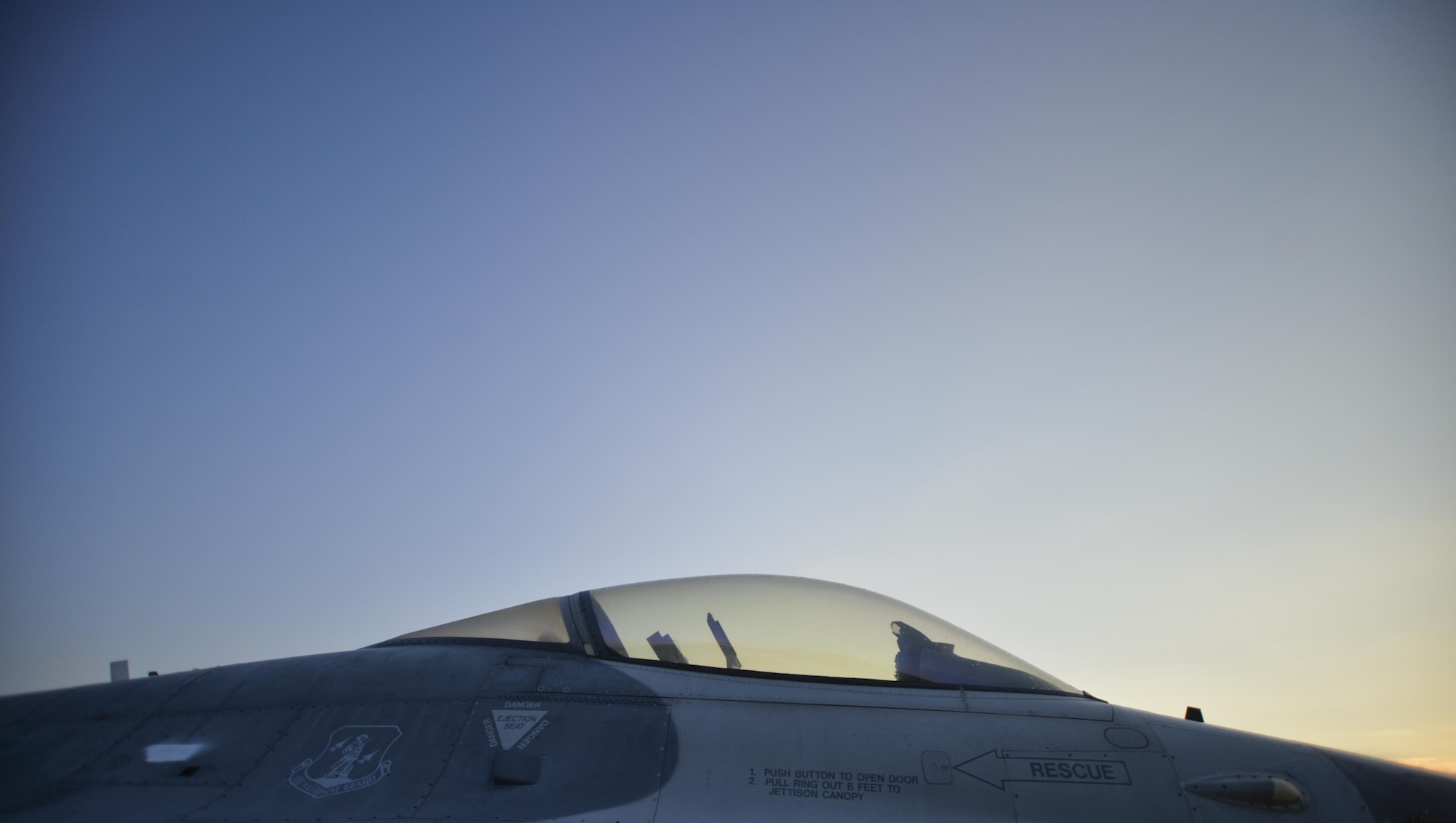 An unmanned QF-16 Full Scale Aerial Target from the 82nd Aerial Targets Squadron is illuminated by the rising sun at Tyndall Air Force Base, Fla., Sept. 29, 2016. The QF-16 unmanned aerial targets program is operated through the 53rd Weapons Evaluation Group on Tyndall Air Force Base. (U.S. Air Force photo by Tech. Sgt. Javier Cruz/Released)