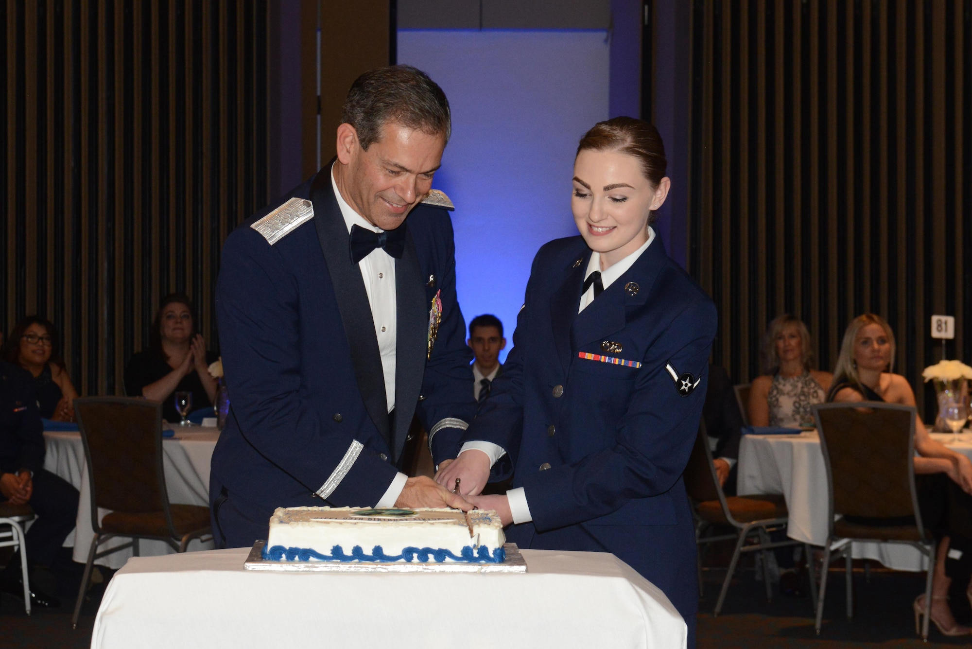 Air Force Lt. Gen. Kenneth Wilsbach, commander of the North American Aerospace Defense Command, Alaskan NORAD Region, U.S. Northern Command, Alaskan Command, and 11th Air Force, and Airman Savanna Soukey, 3rd Maintenance Squadron Raptor Aerospace Ground Equipment specialist, cut a cake during the 2016 Joint Base Elmendorf-Richardson Air Force Ball at the Anchorage Egan Center, Alaska, Sept. 24, 2016. This event marked the Air Force’s 69th birthday celebrating the Air Force’s heritage through reflection, ceremony and camaraderie.