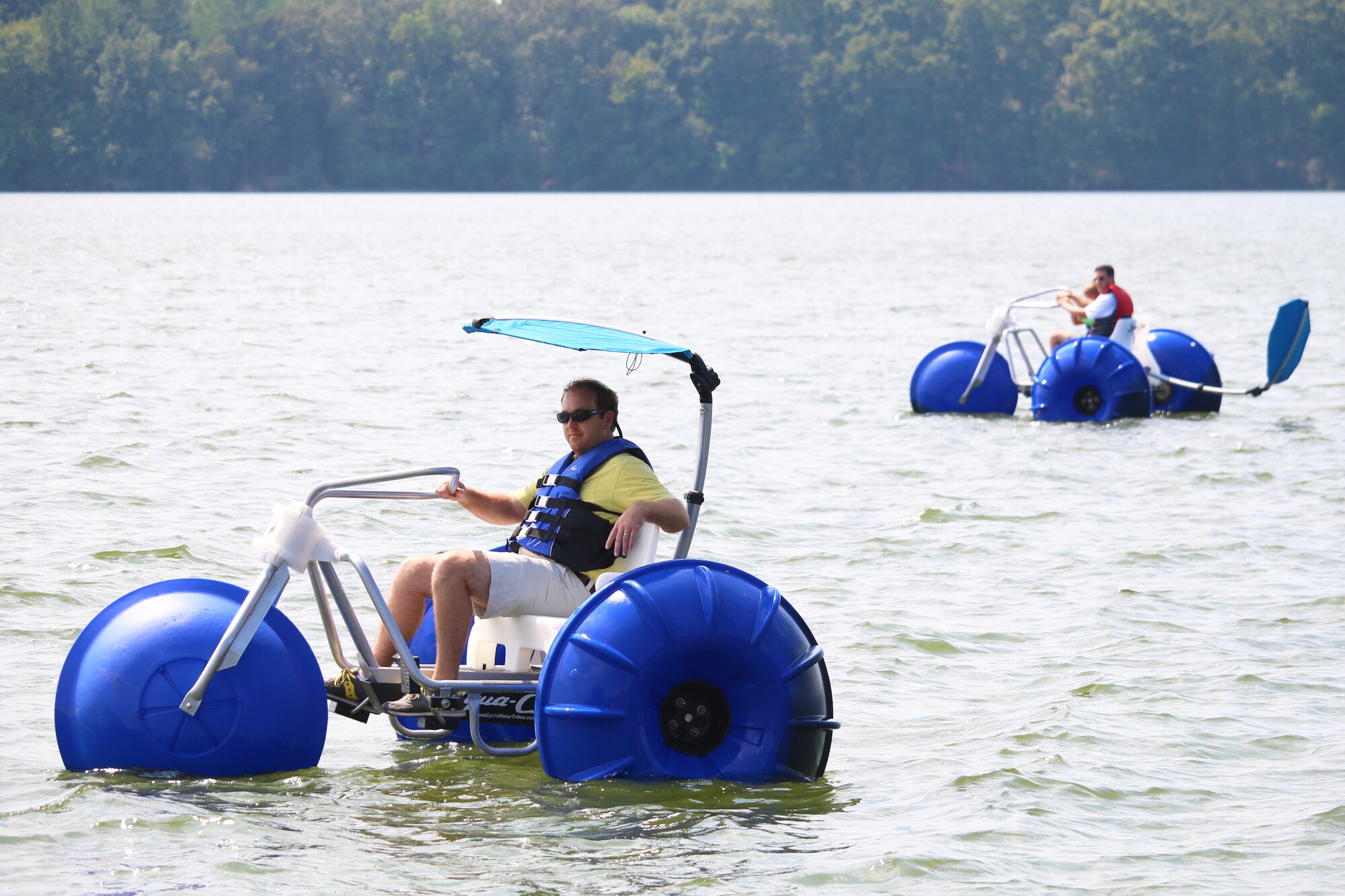 AEDC team members cruise around Woods Reservoir on water tricycles during Air Force birthday fair. (U.S. Air Force photos/Holly Peterson)