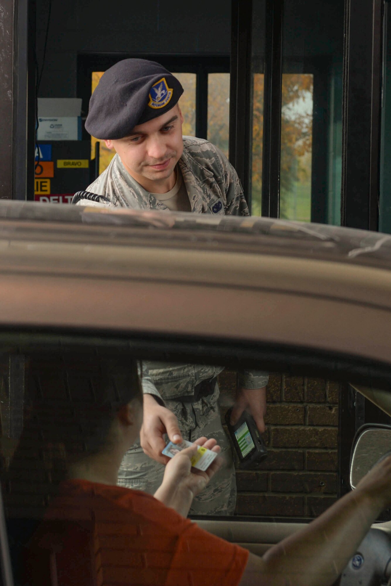 Senior Airman Tyler Serr, an installation entry controller assigned to the 5th Security Forces Squadron, hands back an ID at Minot Air Force Base, N.D., Sept. 30, 2016. ECs remain vigilant 24/7 to ensure safety of the entire military installation. (U.S. Air Force photo/Airman 1st Class Jessica Weissman)