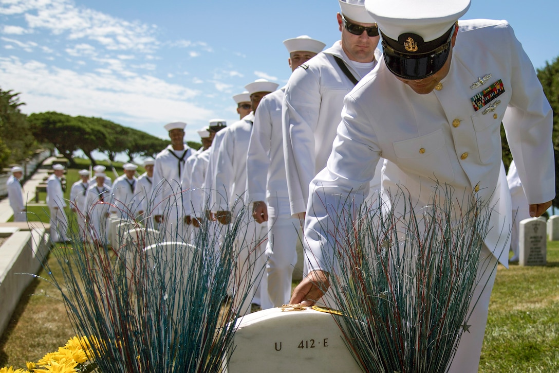 Sailors pay their respects at the grave of Navy Petty Officer 2nd Class Michael Monsoor, a Navy SEAL, on the 10-year anniversary of his death, at Fort Rosecrans National Cemetery in San Diego, Sept. 29, 2016. Monsoor posthumously received the Medal of Honor in 2008 for his heroic actions while serving in Ramadi, Iraq. The sailors are assigned to the USS Michael Monsoor. Navy photo by Petty Officer 2nd Class Abe McNatt
