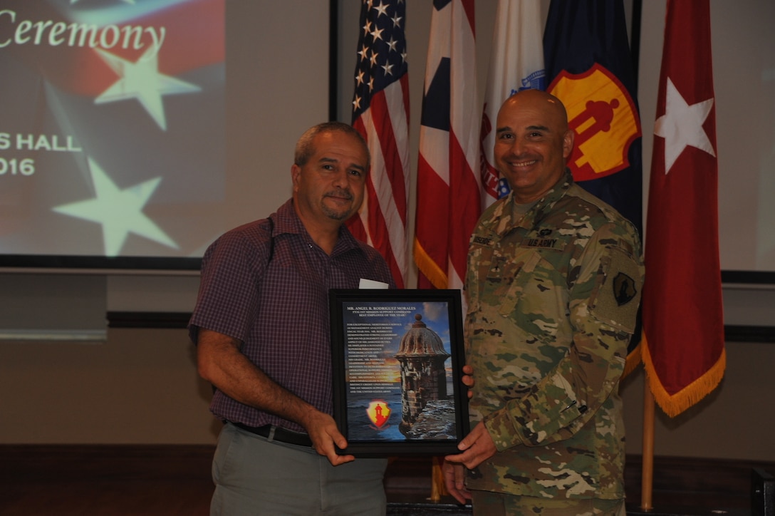 Mr. Angel R. Rodriguez Morales (Left), 1st Mission Support Command management analyst received the Best Employee of the Year award, given by Brig. Gen. Alberto C. Rosende (Right), 1st MSC commanding general, inside the Ramos Hall at Fort Buchanan, Puerto Rico on September 29.