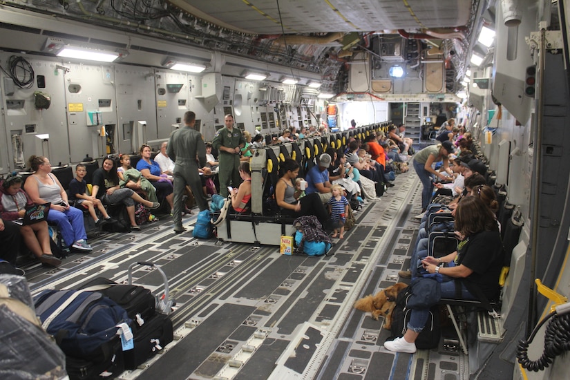 Families from Naval Station Guantanamo Bay, Cuba, settle into their seats aboard a Boeing C-17A Globemaster III aircraft for evacuation ahead of Hurricane Matthew, Oct. 2, 2016. About 700 spouses, children and pets were evacuated to Naval Air Station Pensacola, Fla., until the hurricane passes. Base tenant commands and 4,800 personnel remain to continue preparations for the storm. Hurricane condition of Readiness 2 was set base wide in preparation for destructive winds within 24 hours. Army photo by Capt. Frederick H. Agee