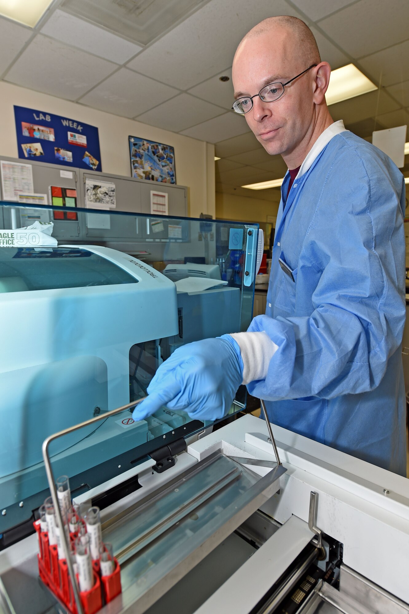 Staff Sgt. Kevin Arnett, 359th Clinical Laboratory and Radiology Flight medical lab technician, loads blood samples in a chemistry analyzer at the 359th Medical Group lab at Joint Base San Antonio-Randolph, Texas, Sept. 16, 2016. The analyzer checks that a patient’s body and organs are functioning properly. (U.S. Air Force photo/Tech. Sgt. Christopher Carwile/Released).