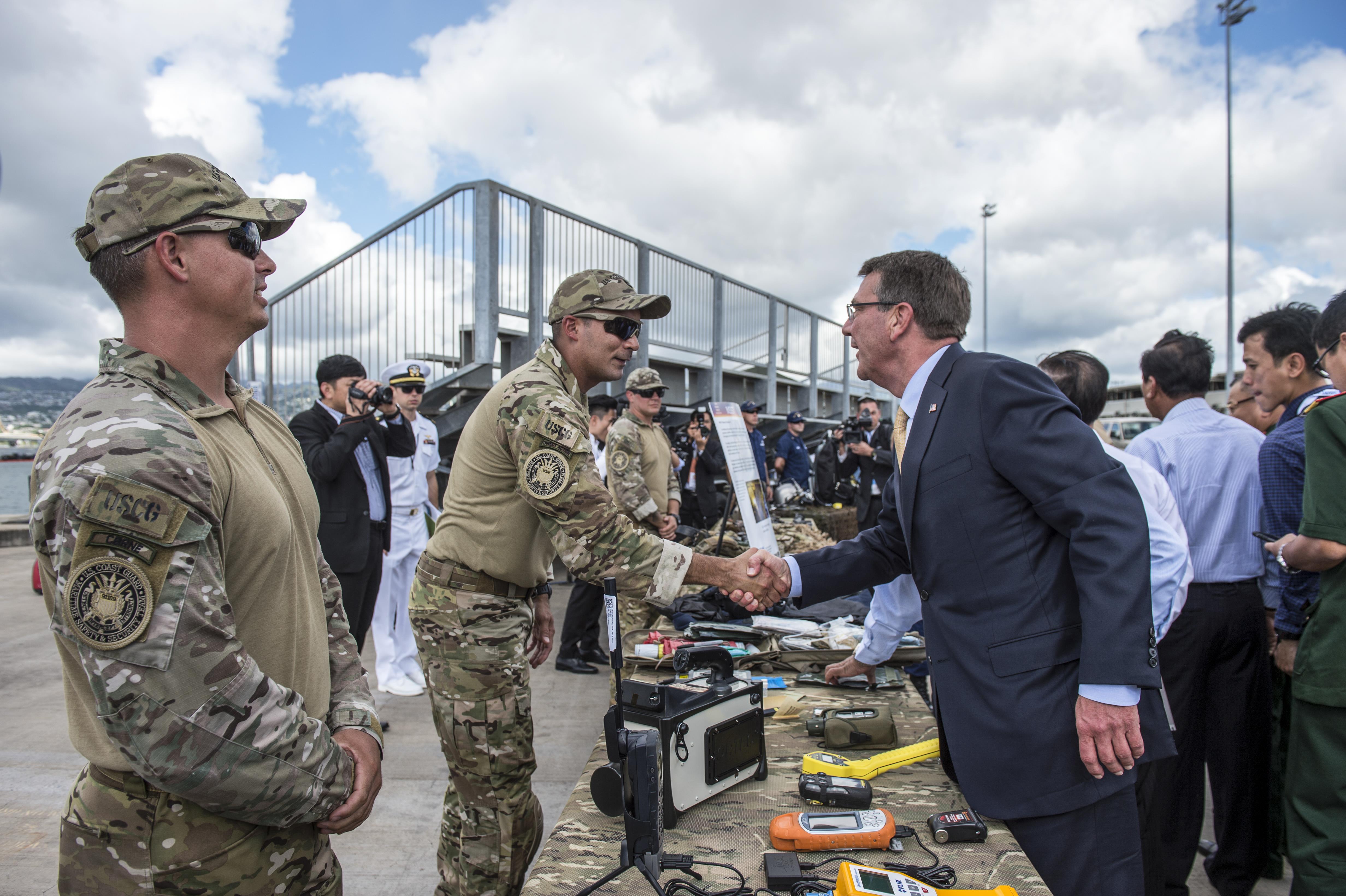 Defense Secretary Ash Carter shakes hands with a Coast Guardsman