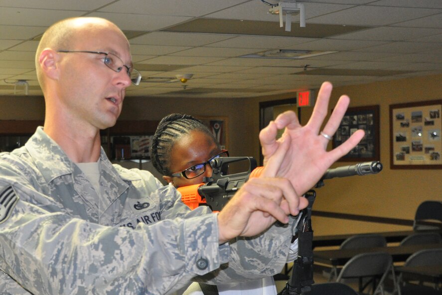 YOUNGSTOWN AIR RESERVE STATION, Ohio–Staff Sgt. John Hall, a 910th Security Forces Squadron fire team member, shows how to obtain a correct sight picture for an M4 assault rifle to an attendee during the 4th Annual Joint Employer Awareness Event while using a weapons training simulation program at the SFS complex here, Aug. 12, 2016. The two-day event, designed to give civilian employers of Reservists and National Guardsmen a better understanding of the mission their employees carry out as members of the U.S. Armed Forces, also gave attendees the opportunity to get an up-close look at the U.S. Coast Guard Station and U.S.S. Cod World War II Navy Submarine memorial at the Port of Cleveland as well as the 910th Airlift Wing's facilities here. (U.S. Air Force photo/Master Sgt. Bob Barko Jr.)