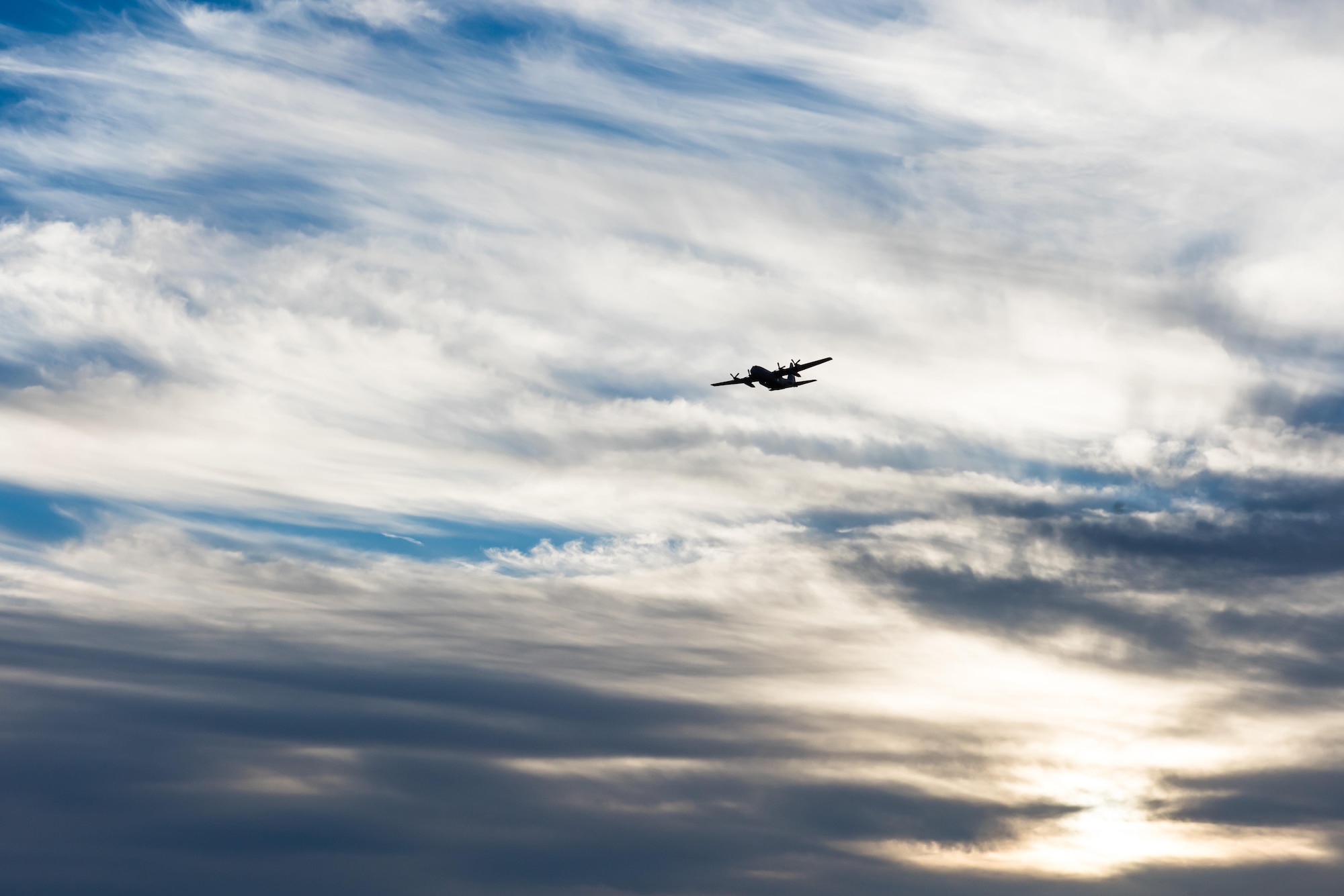 A modified C-130 Hercules soars overhead as it prepares to spray herbicide at the Saylor Creek Training Range, Idaho, Sept. 17, 2016. Two prongs located in its mid-section emit a mixture of water and herbicides to spray large areas. (U.S. Air Force photo by Senior Airman Connor J. Marth/Released)