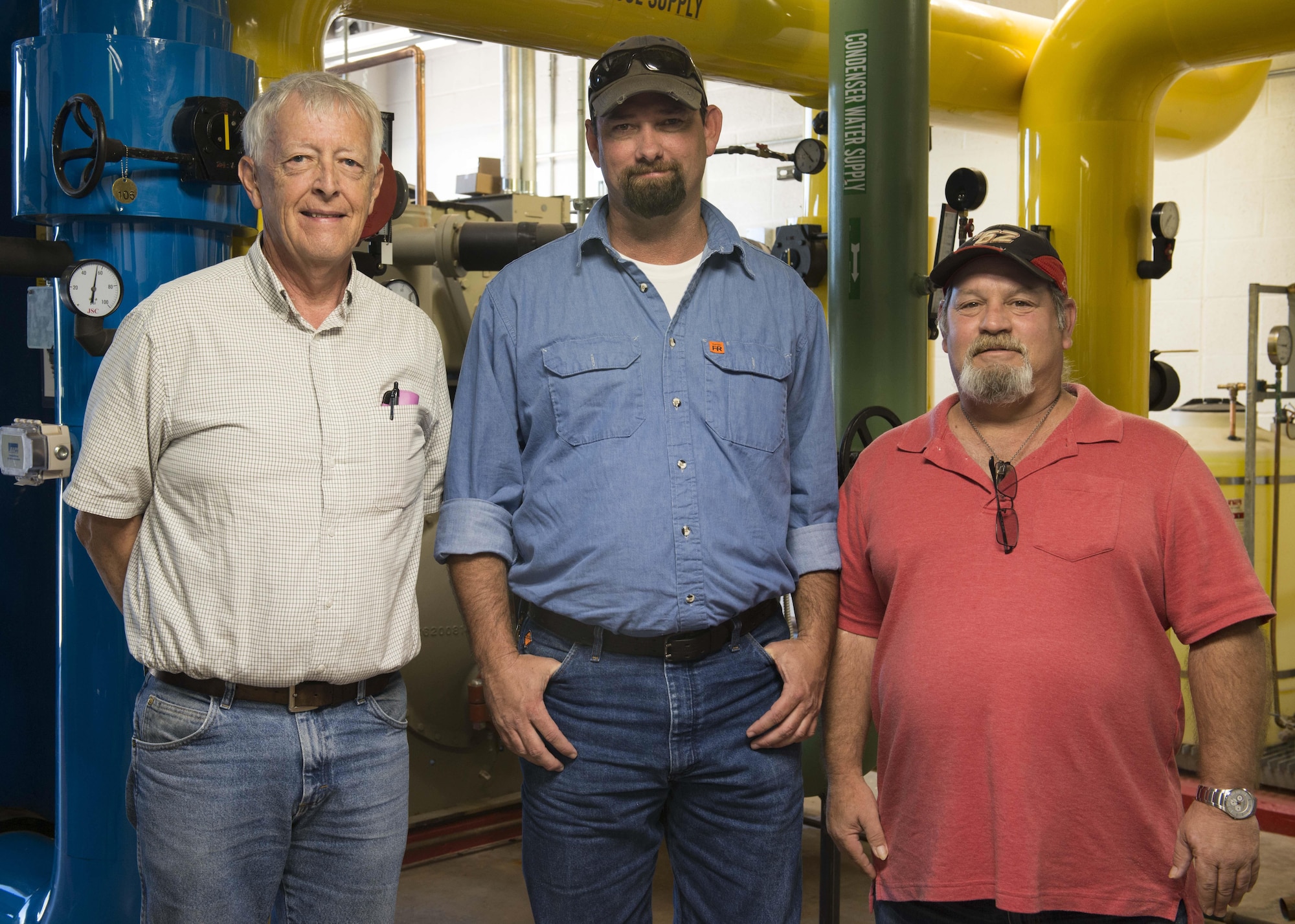Three of the five members of the Dyess Energy Team stand for a group photo at the Dyess Ice Plant during an immersion at Dyess Air Force Base, Texas, Oct. 3, 2016. The Dyess Energy Team recently won a Federal Energy and Water Management Program Award due to taking on three projects that have helped the base cut down on energy usage, money and manpower hours. (U.S. Air Force Photo by Airman 1st Class Katherine Miller/Released)