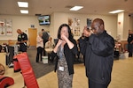 Lt. Bruce Jacobs, Defense Logistics Agency Installation Support at Richmond police training officer, shows Rebecca Bartlett, Virginia Dominion Power, safety chair, the best way to defend against an attacker during a National Preparedness Fair Sept. 28, 2016 at Defense Supply Center Richmond. Bartlett visited the fair to gain insight on conducting one for her organization. 