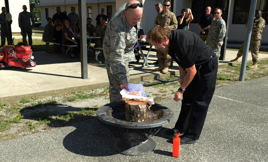 Col. David Piech, Air Force Special Operations Command A7 director, burns A7 paperwork at Hurlburt Field, Fla., Sept. 30, 2016. To celebrate the memory of the last A7 directorate in the Air Force, the staff had an informal Irish Wake-themed ceremony. The AFSOC A7 directorate is part of A4 as of Oct. 3, 2016. (U.S. Air Force photo/Staff Sgt. Melanie Holochwost)