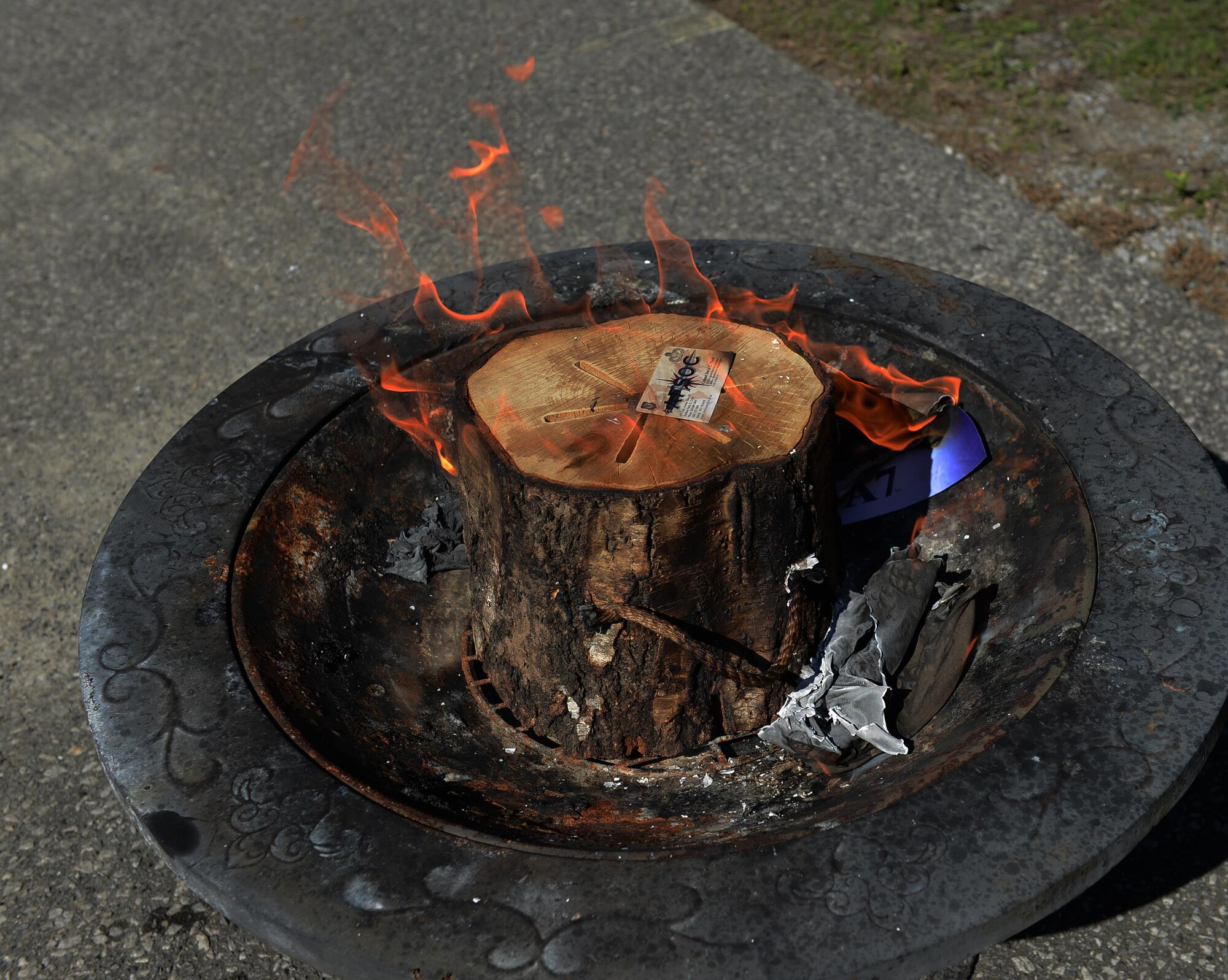 An A7 business card burns in a fire pit at Hurlburt Field, Fla., Sept. 30, 2016. Air Force Special Operations Command’s A4 directorate has absorbed A7. “It doesn’t matter who is in charge, it’s about supporting the warfighter … supporting our Air Commandos,” said Col. David Piech, AFSOC’s last A7 director, at the Irish Wake-themed ceremony. (U.S. Air Force photo/Staff Sgt. Melanie Holochwost)