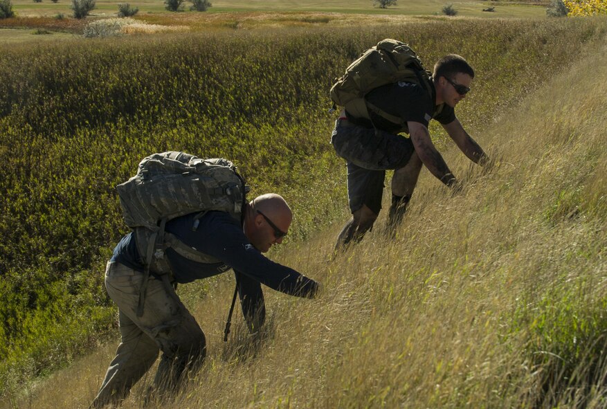 Airmen climb a steep hill during the GoRuck Team Cohesion Challenge at Minot Air Force Base, N.D., Sept. 29, 2016. This was the third annual year the base has hosted the event. (U.S. Air Force photo/Senior Airman Apryl Hall)